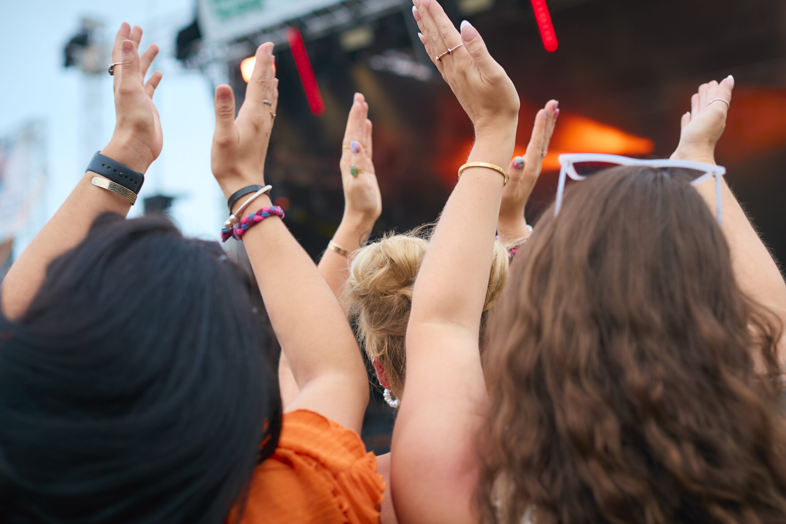 Rear View Of Audience Enjoying Concert At Outdoor Summer Music Festival